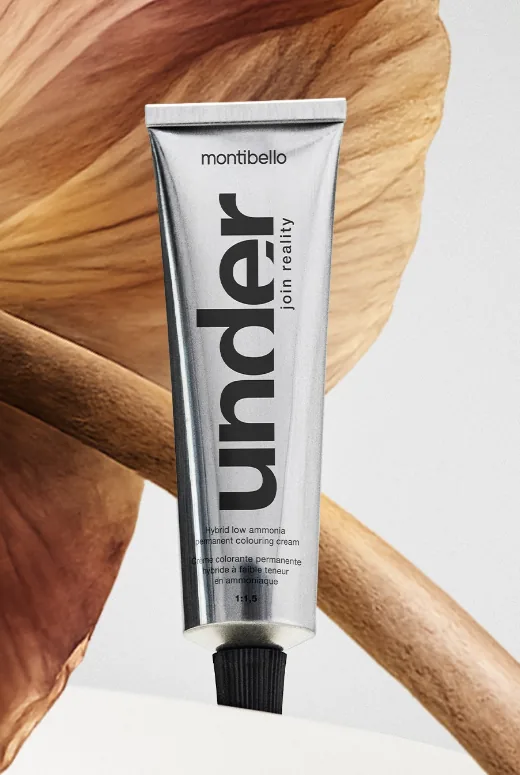 An Under colouring cream tube resting on a dried petal