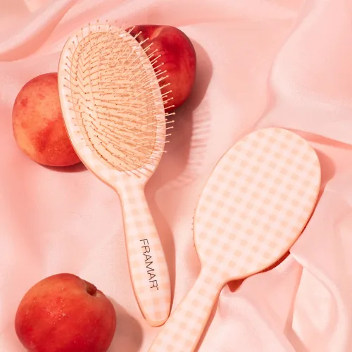 Two Framar Peach Please Belle detangle brushes in peach gingham among peaches